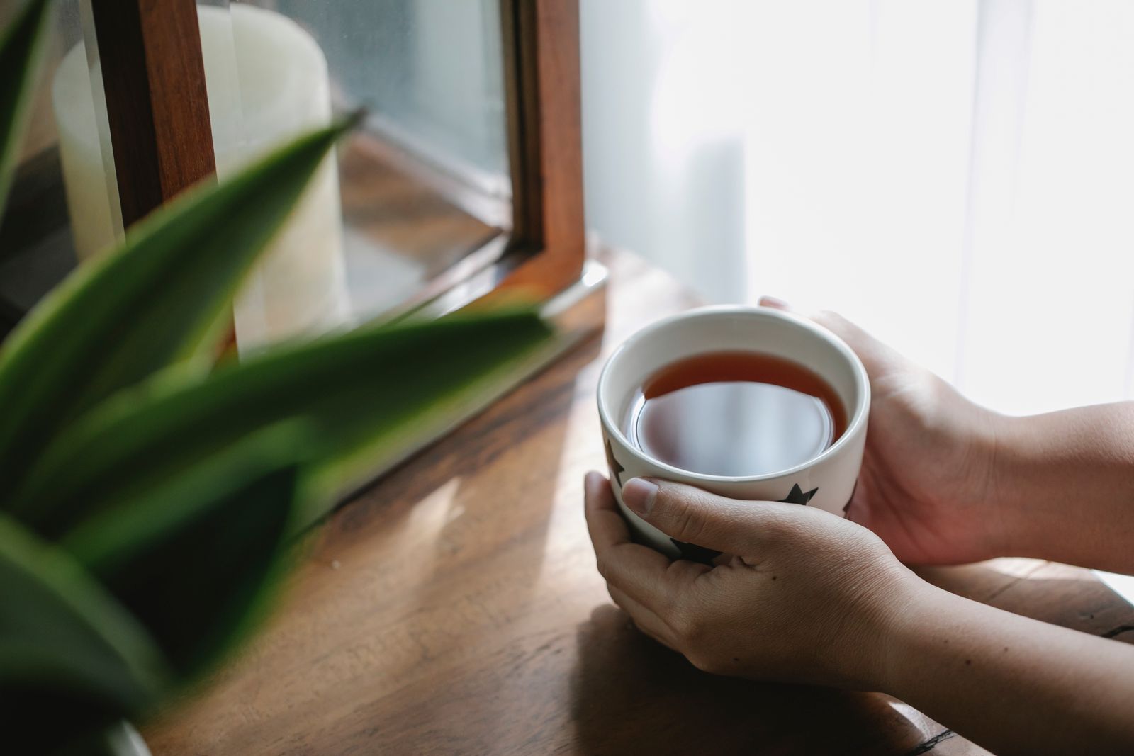 Tasse de tisane à la camomille posée sur un livre ouvert